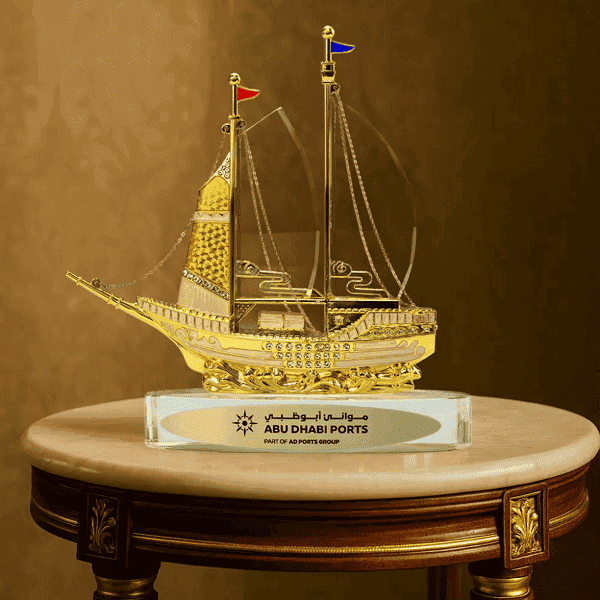 Voyage – Golden Boat Shaped Memento in Metal with Glass Base detail 3